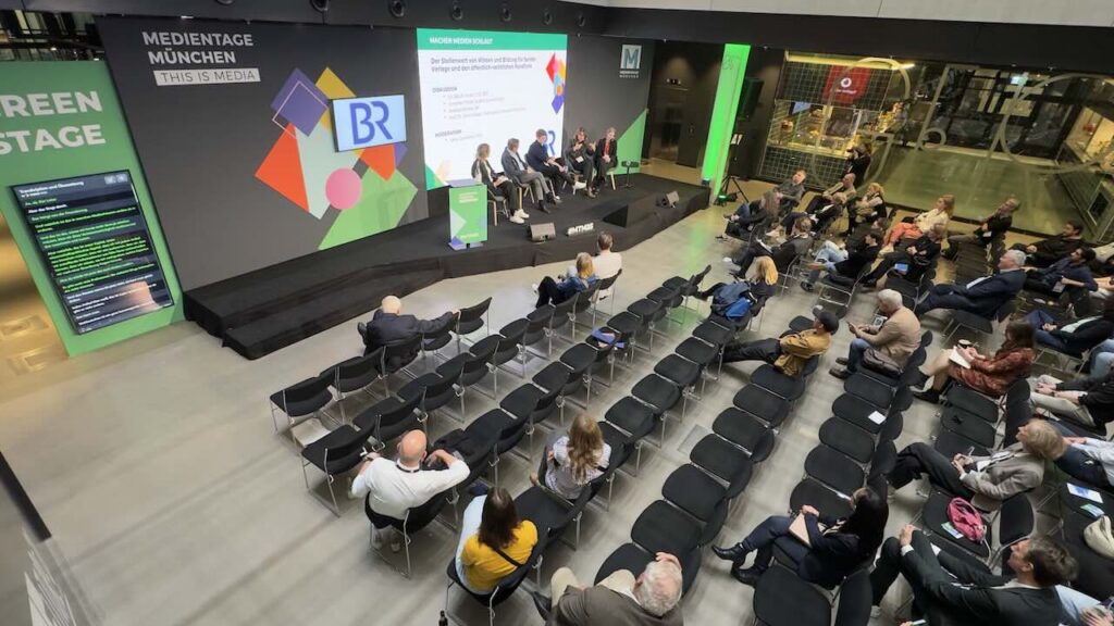 Trade fair stage with live translation captions at Medientage Munich